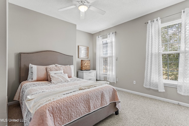 carpeted bedroom with a textured ceiling and ceiling fan