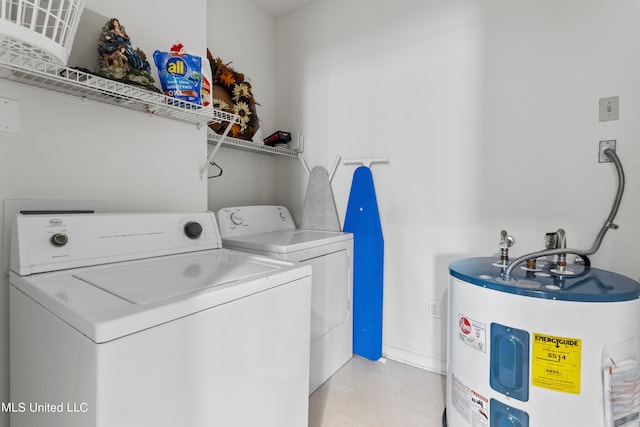 clothes washing area featuring electric water heater and washing machine and clothes dryer