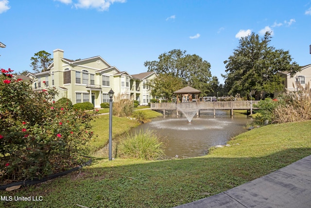 view of home's community featuring a gazebo, a yard, and a water view