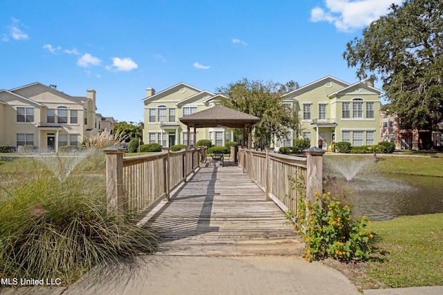 view of home's community featuring a gazebo and a water view