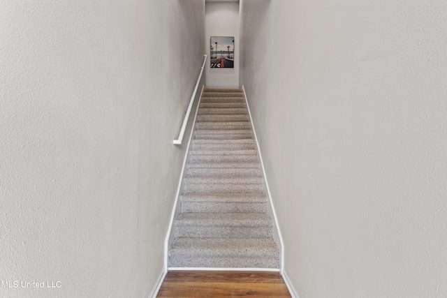 stairs featuring wood-type flooring