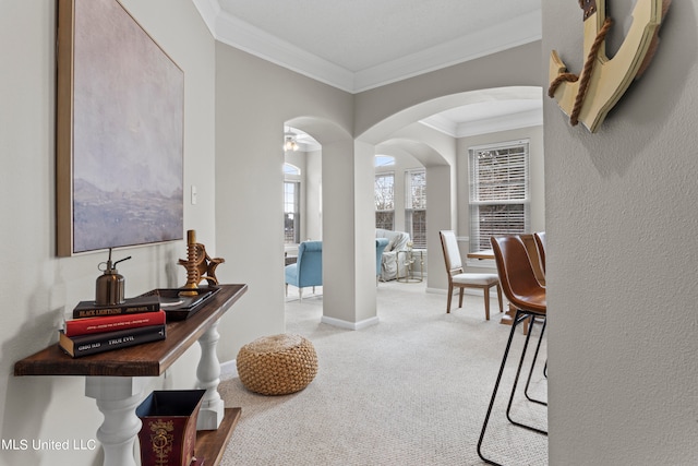 corridor with crown molding and light colored carpet