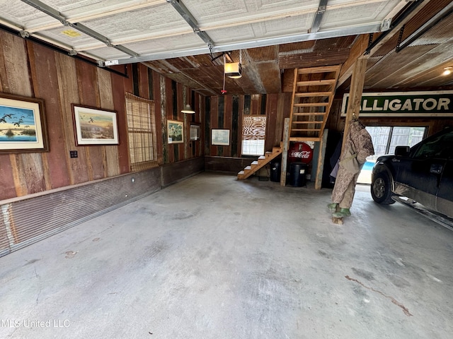 14 Fava St, Alligator, MS 38720 - garage featuring a garage door opener and wooden walls