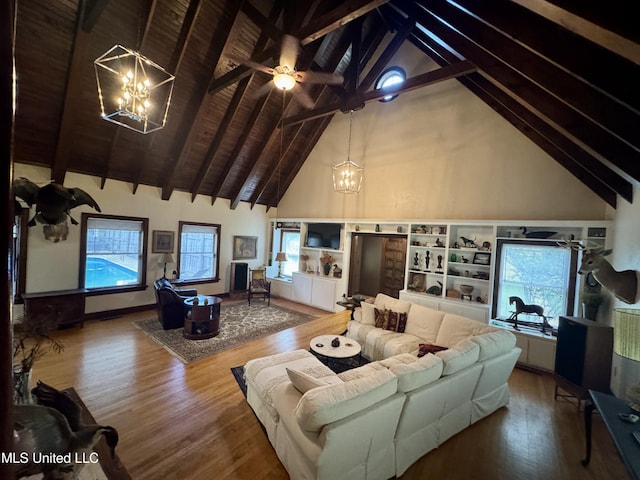 14 Fava St, Alligator, MS 38720 - living area featuring a chandelier, high vaulted ceiling, plenty of natural light, wood finished floors, and beamed ceiling