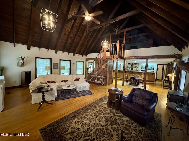 14 Fava St, Alligator, MS 38720 - living area featuring high vaulted ceiling, a chandelier, a ceiling fan, beam ceiling, and wood finished floors