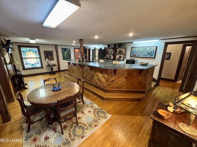 14 Fava St, Alligator, MS 38720 - indoor bar with light wood-type flooring, freestanding refrigerator, and a textured ceiling