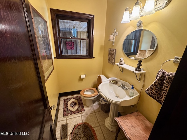 14 Fava St, Alligator, MS 38720 - bathroom featuring tile patterned floors and toilet