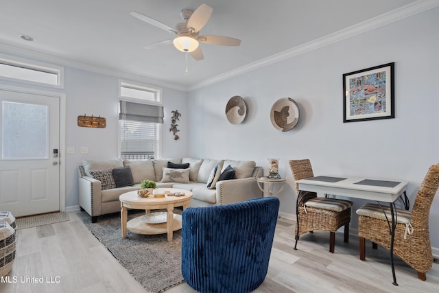 living room featuring crown molding, light hardwood / wood-style flooring, and ceiling fan