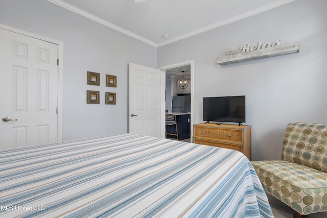 bedroom with a chandelier, stainless steel refrigerator, a closet, and ornamental molding