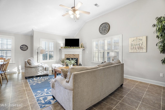 tiled living room with lofted ceiling, a brick fireplace, plenty of natural light, and ceiling fan