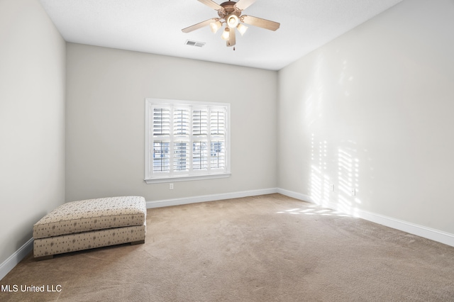 sitting room featuring carpet and ceiling fan