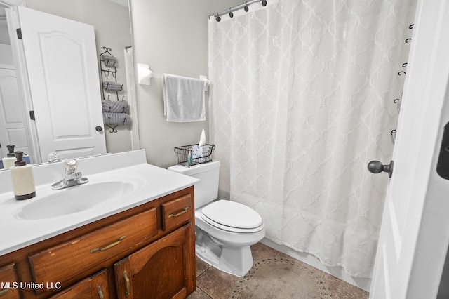 bathroom with walk in shower, vanity, toilet, and tile patterned flooring