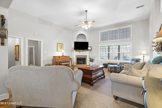 carpeted living room featuring crown molding and ceiling fan