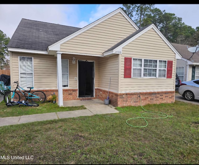 bungalow-style home with a front lawn