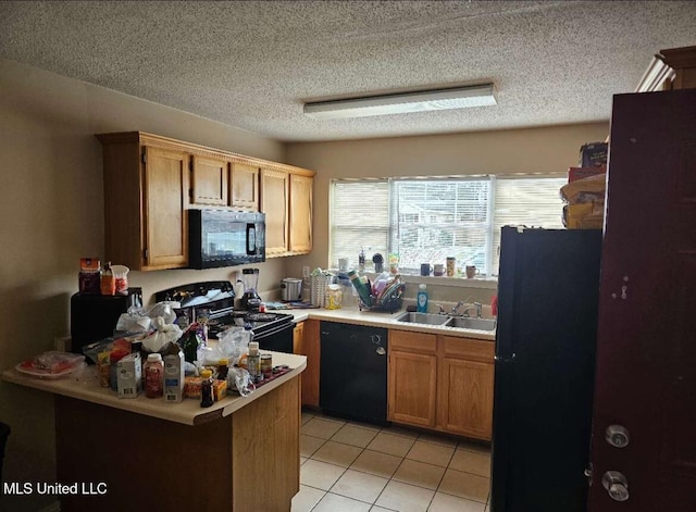 kitchen with light tile patterned floors, sink, a textured ceiling, and black appliances