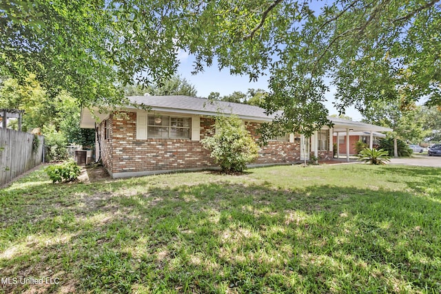 ranch-style house featuring central AC and a front lawn