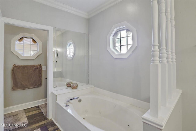 bathroom featuring hardwood / wood-style floors, crown molding, a healthy amount of sunlight, and a bathing tub