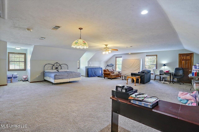 bedroom with lofted ceiling, carpet, multiple windows, and a textured ceiling