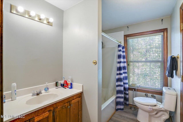 full bathroom with a wealth of natural light, vanity, hardwood / wood-style floors, and toilet