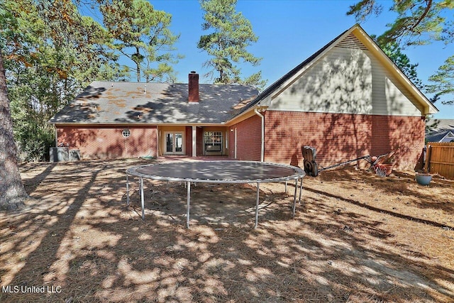 back of house featuring a trampoline