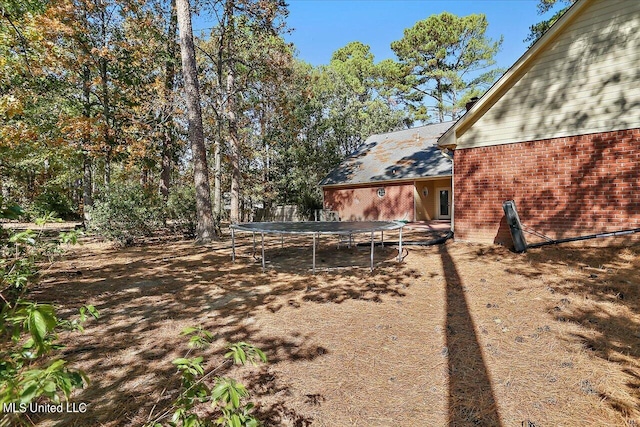 view of yard with a trampoline