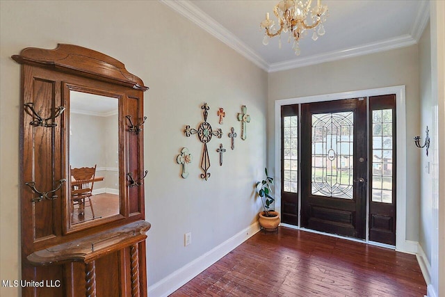 foyer entrance with crown molding, dark hardwood / wood-style flooring, and an inviting chandelier