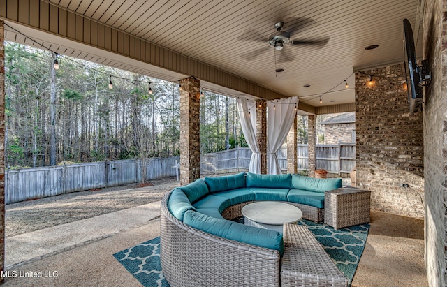 view of patio featuring a fenced backyard, an outdoor living space, and a ceiling fan