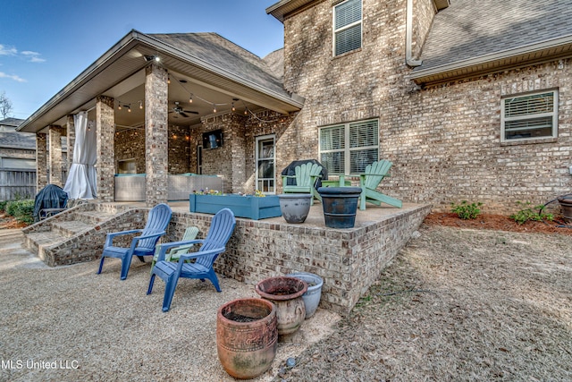 view of patio with an outdoor fire pit and ceiling fan