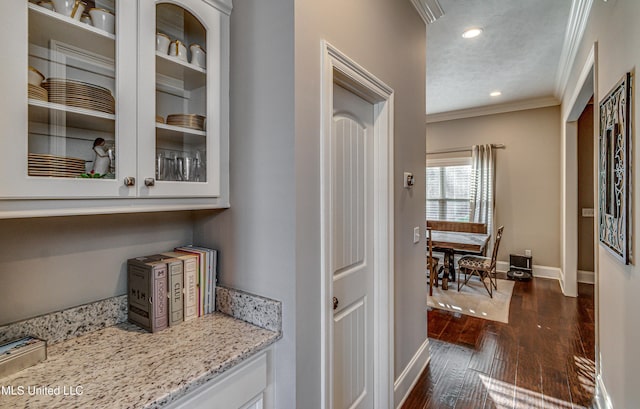 bar featuring ornamental molding, recessed lighting, dark wood finished floors, and baseboards