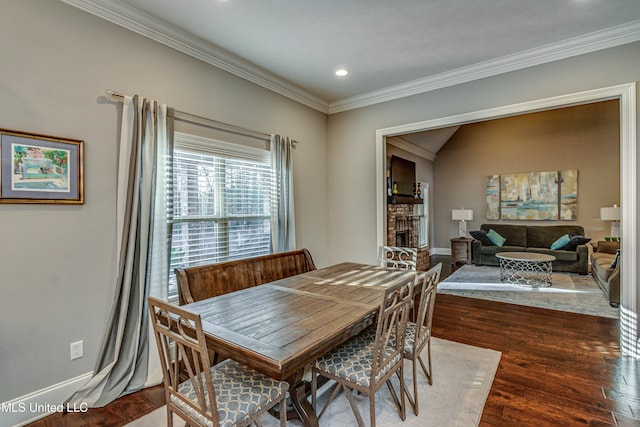 dining space with crown molding, baseboards, wood finished floors, and recessed lighting