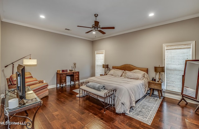 bedroom with ornamental molding, multiple windows, and hardwood / wood-style flooring