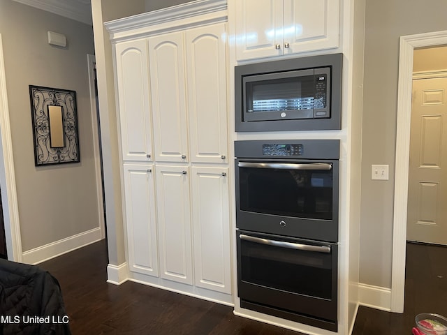 kitchen with baseboards, white cabinets, dark wood-style floors, double wall oven, and built in microwave