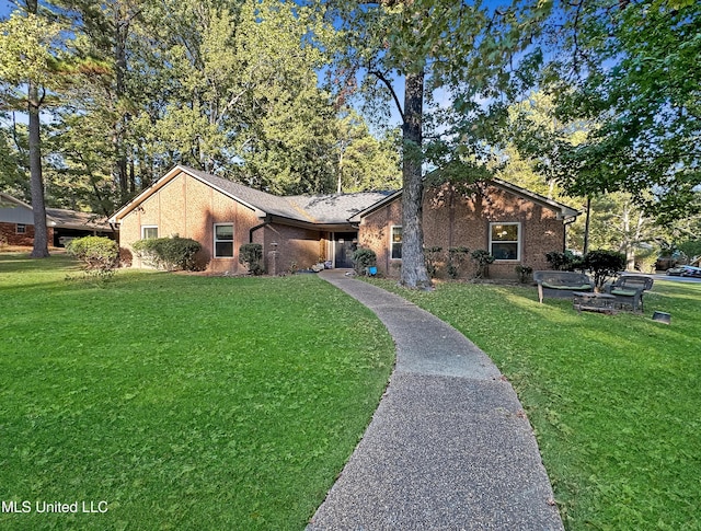 mid-century home with a front lawn and brick siding