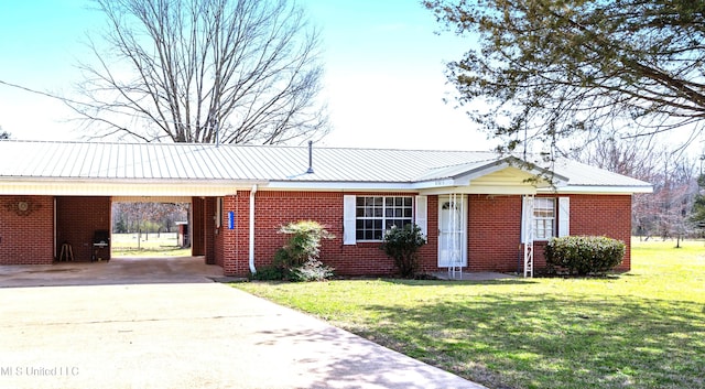 single story home with driveway, brick siding, a front lawn, an attached carport, and metal roof