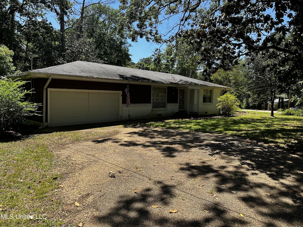 2238 Alta Woods Ter, Jackson, MS 39204 - view of front of house featuring dirt driveway, an attached garage, and a front yard