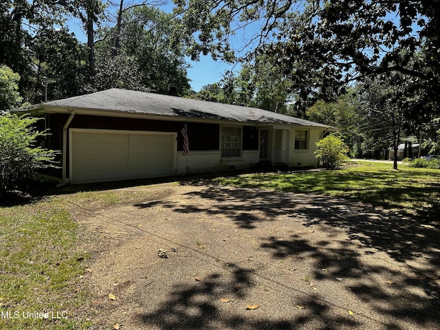 2238 Alta Woods Ter, Jackson, MS 39204 - view of front of house featuring dirt driveway, an attached garage, and a front yard