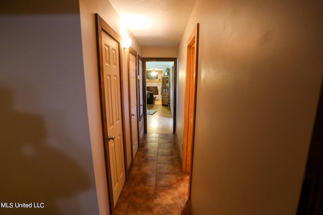hallway with dark tile patterned flooring
