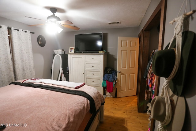bedroom with ceiling fan and light hardwood / wood-style floors