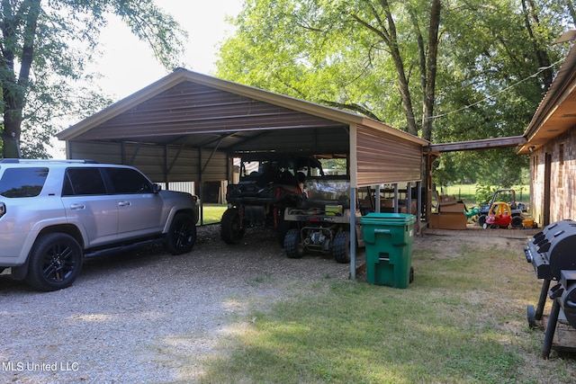 view of vehicle parking with a yard and a carport