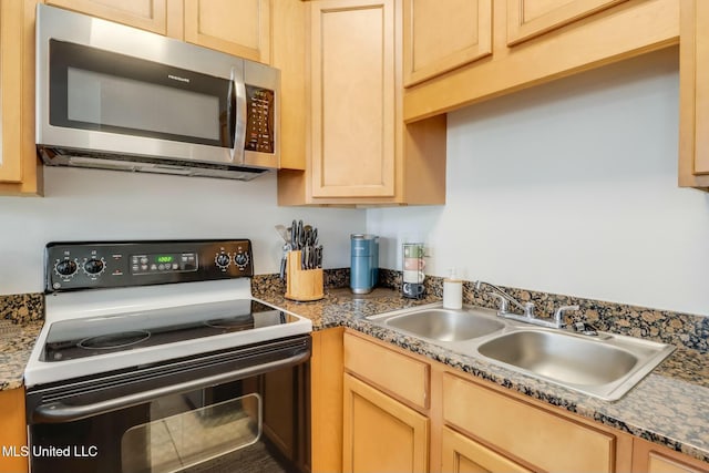 kitchen featuring a sink, stainless steel microwave, range with electric stovetop, and light brown cabinets