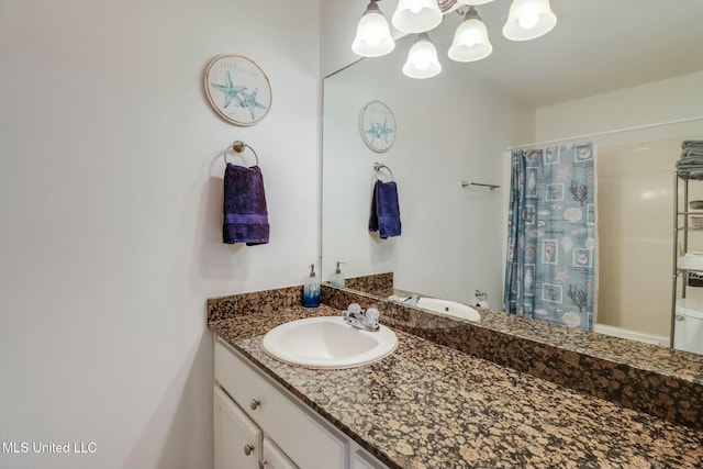 bathroom with vanity, a shower with shower curtain, and a chandelier