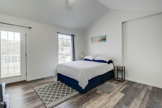 bedroom featuring a ceiling fan, vaulted ceiling, wood finished floors, and baseboards