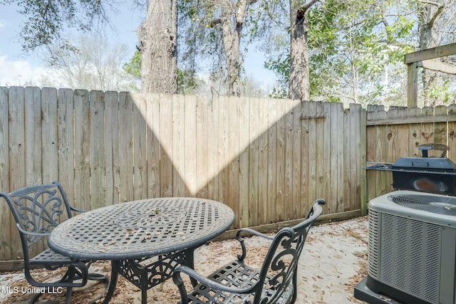 view of patio with cooling unit, area for grilling, and a fenced backyard