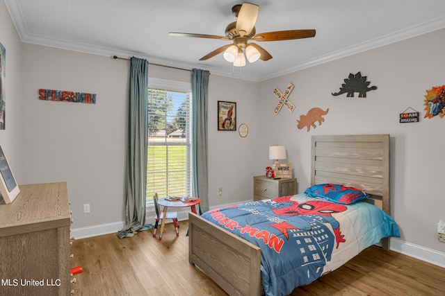 bedroom featuring ceiling fan, hardwood / wood-style flooring, and ornamental molding