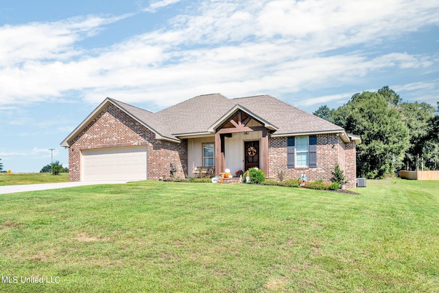 view of front of house with a front yard, central AC, and a garage