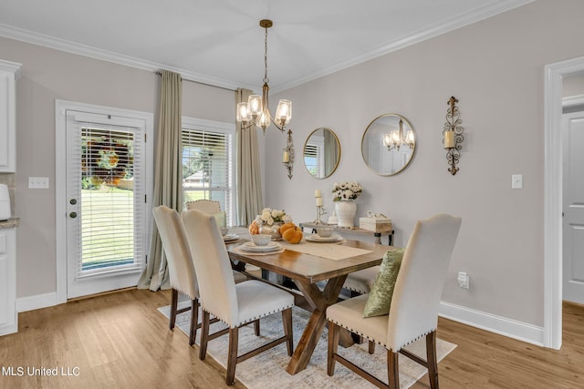 dining area with light hardwood / wood-style floors, an inviting chandelier, and ornamental molding