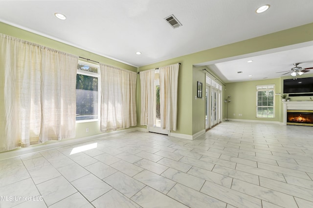 unfurnished living room with ceiling fan