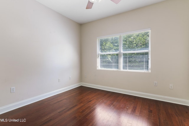 unfurnished room featuring dark wood-type flooring and ceiling fan