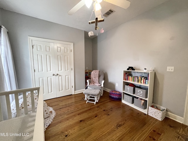 interior space with wood-type flooring, ceiling fan, and a closet