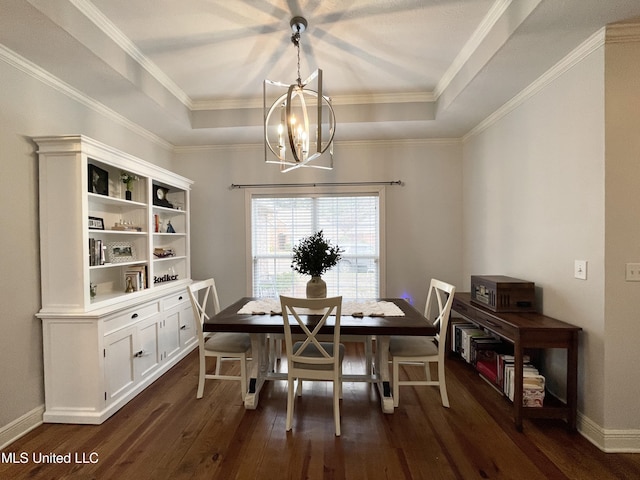 dining area with dark hardwood / wood-style flooring, a tray ceiling, crown molding, and a chandelier